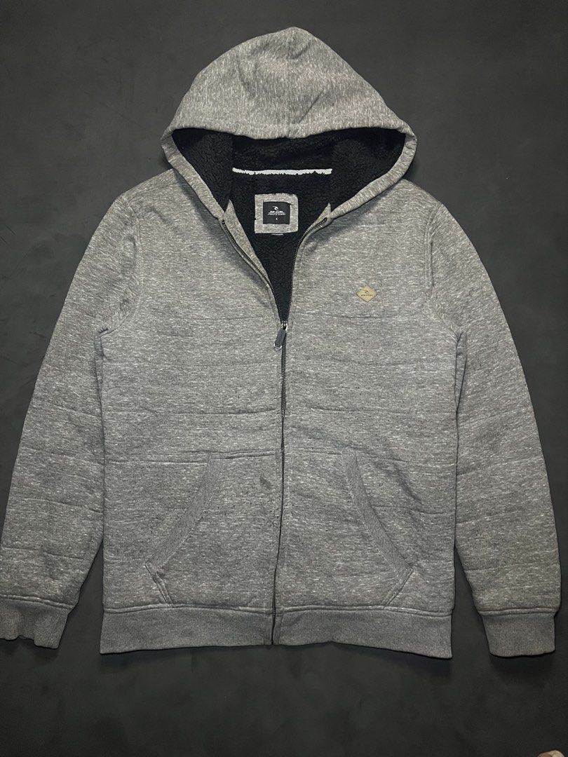 Rip Curl Sherpa Lined Grey Zip Hoodie Size S (Category: Coats, Jackets and Outerwear) located in Muntinlupa City. Submitted by pastforwardthrift (Listing ID 1470124088, Image 1). Description: - Brand: Rip Curl - Size: Small - Color: Grey with soft black sherpa lining inside the hood and body - Features: Front split kangaroo pocket and branded metal zipper pull - Origin: Made in Cambodia - Condition: Great for keeping warm and stylish during cold 