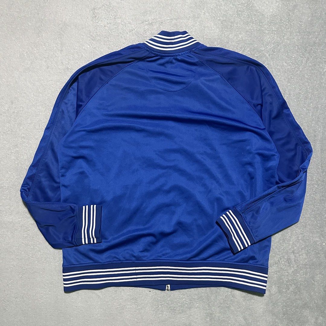Rocawear Classic Blue Track Jacket Size 2XL (Category: Coats, Jackets and Outerwear) located in Bayombong. Submitted by rochelle_archive_garments (Listing ID 1470038571, Image 3). Description: - Brand: Rocawear Classic - Color: Royal Blue - Size: 2XL - Material: 100% polyester (machine washable) - Design: Full zip front, ribbed collar/cuffs/hem with white stripes, and embroidered chest logo - Pockets: Two front slash pockets - Condition: Great st