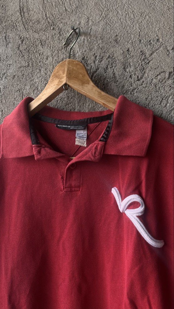 Rocawear Red Polo Shirt Size Medium (Category: Tshirts & Polo Shirts ) located in Cabuyao City. Submitted by bulandos (Listing ID 1470033169, Image 2). Description: - Brand: Rocawear (Est. 1999) - Size: Medium - Material: 100% Cotton - Origin: Made in Vietnam - Details: Textured pique fabric, embroidered R logo on chest and back collar, classic collar with single-button placket.
