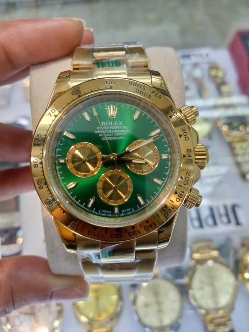 Rolex Cosmograph Daytona Gold Green Dial (Category: Luxury Watches) located in Las Pinas. Submitted by teampeewee888 (Listing ID 1470016439, Image 2). Description: - Model: Rolex Daytona Chronograph - Dial: Green with gold subdials and baton markers - Bezel: Polished gold tachymeter bezel - Bracelet: Oyster bracelet (still with protective plastic film) Japan made Premium - Movement: Automatic - Features: Crown guards and screw-down pushers - Cond