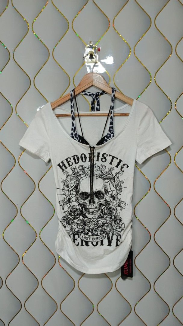 ROMWE White Skull Graphic Zip-Front (Category: Shirts) located in Manila. Submitted by zariyah.1986 (Listing ID 1469952317, Image 1). Description: - Brand: ROMWE - Style: Edgy / Y2K / Grunge - Design: White short sleeve tee with built-in black and white halter layer - Details: Large skull and floral graphics, 'HEDONISTIC LOST ECHOES' lettering - Neckline: working zipper and cross zipper pull - Fit: Side ruching detail for a flattering look - Occa