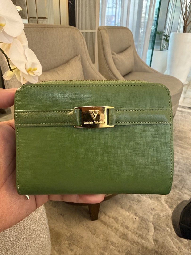 Rudolp Valentino Green Wallet (Category: Luxury Bags & Wallets) located in Quezon City. Submitted by Cristian (Listing ID 1470054262, Image 1). Description: Rudolph Valentino ( Vintage wallet) • Color: Vibrant Emerald Green • Material: Premium textured Saffiano leather (highly durable and scratch-resistant) • Hardware: Polished gold-tone front plaque featuring the iconic split “V” logo and cursive brand engraving. • Closure: Secure, smooth wrap-a