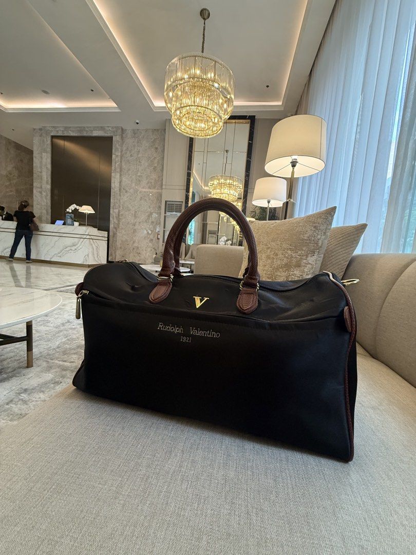 Rudolph Valentino duffel bag (Category: Briefcases) located in Quezon City. Submitted by Cristian (Listing ID 1470103811, Image 2). Description: Rudolph Valentino travel duffel / boston bag Missing detachable shoulder strap.