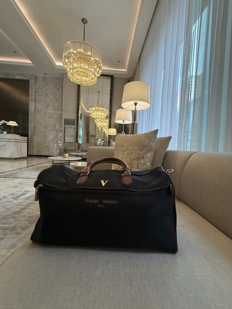 Rudolph Valentino duffel bag (Category: Briefcases) located in Quezon City. Submitted by Cristian (Listing ID 1470103811, Image 1). Description: Rudolph Valentino travel duffel / boston bag Missing detachable shoulder strap.