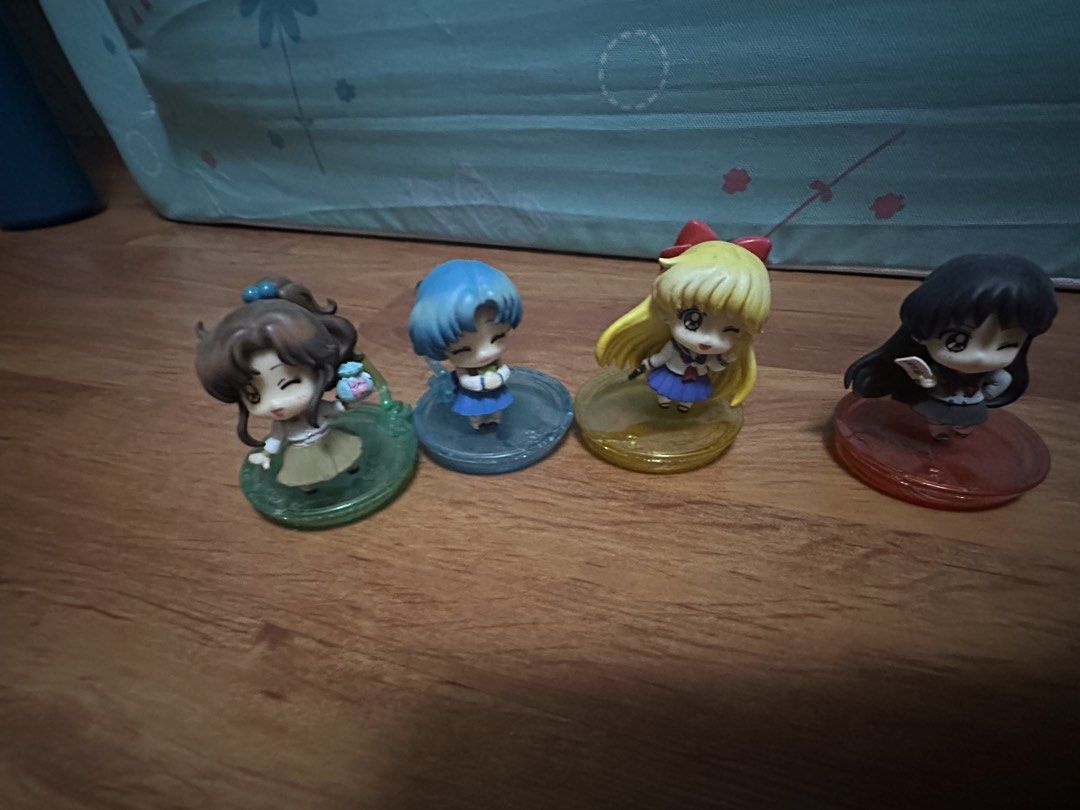 Sailor Moon figures, purses, camera, and star fan bundle (Category: Figurines & Statues) located in Del Monte. Submitted by valin. (Listing ID 1469979399, Image 3). Description: - Massive Sailor Moon collection for fans and collectors - Includes mini chibi figures with stands (Sailor Moon, Mercury, Mars, Venus, Jupiter, and Chibi Moon) - Comes with 2 cute heart pouches - Includes a pink toy camera decorated with stickers - Features a star-shaped 