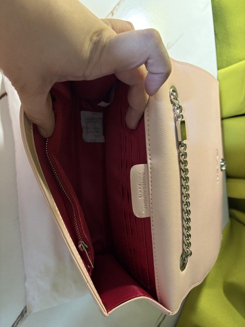 Saint Laurent Kate Medium Tassel Chain Bag (Category: Clutches) located in Borongan. Submitted by charmspreloveddd (Listing ID 1470024063, Image 2). Description: Pink grained leather Saint Laurent Kate bag with silver-tone hardware. - Iconic YSL monogram hardware with tassel hanging down. - Silver chain strap. Magnetic closure flap. - Red fabric lining inside with multiple card slots and a zipped pocket. - Dust bag included..