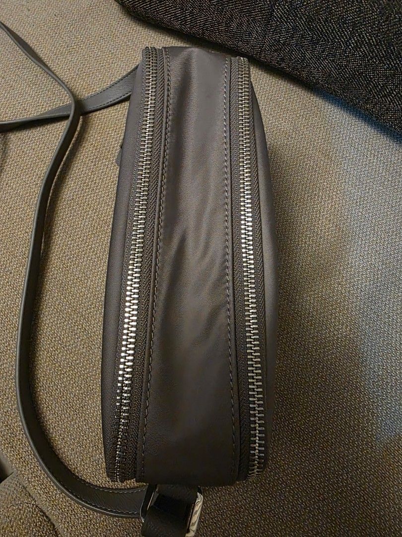 Samsonite Grey Crossbody/Camera Bag (Category: Cross-body Bags) located in Pasig City. Submitted by starfjames (Listing ID 1469979215, Image 2). Description: Pre-loved authentic Samsonite crossbody/camera bag in good condition, used only a few times, no damage. Bought in a Samsonite shop abroad. Soft & lightweight. Adjustable strap. 2 main zip compartments, 1 interior zip pocket. Approx. dimensions: 6 x 8 x 2.5 inches .