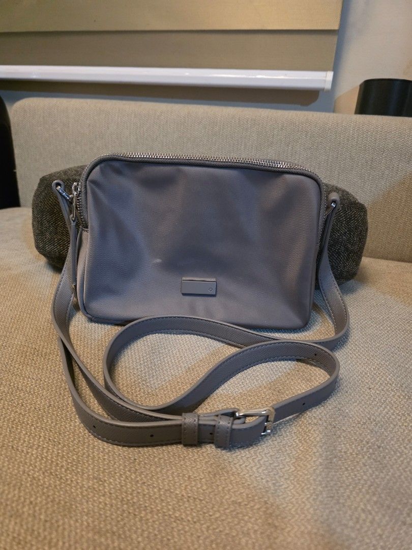 Samsonite Grey Crossbody/Camera Bag (Category: Cross-body Bags) located in Pasig City. Submitted by starfjames (Listing ID 1469979215, Image 1). Description: Pre-loved authentic Samsonite crossbody/camera bag in good condition, used only a few times, no damage. Bought in a Samsonite shop abroad. Soft & lightweight. Adjustable strap. 2 main zip compartments, 1 interior zip pocket. Approx. dimensions: 6 x 8 x 2.5 inches .
