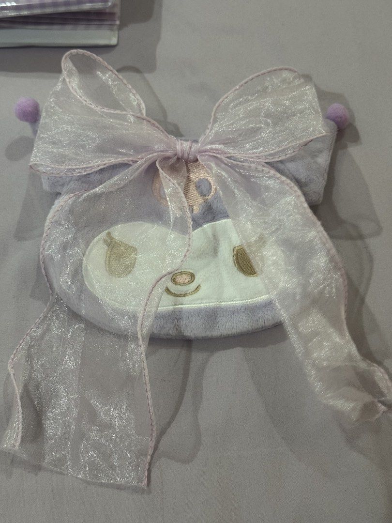Sanrio Kuromi Plush Pouch from gachaa (Category: Purses & Pouches) located in Bacolor. Submitted by mori01927 (Listing ID 1470012857, Image 1). Description: - Authentic Sanrio Kuromi plush pouch in light purple - Features cute embroidered Kuromi face, sheer organza bow, and ear pom poms - Made of ultra-soft, high-quality plush material - Ideal size for everyday makeup, trinkets, and small essentials - Excellent, clean condition with no stains or 
