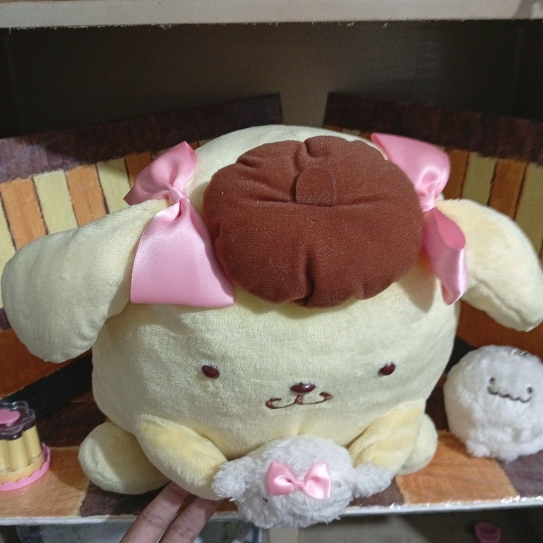 Sanrio Pompompurin eith macaroon (Category: Plushies & Soft Toys) located in Caloocan City. Submitted by thecanceri83884 (Listing ID 1469986255, Image 2). Description: - Official Sanrio - Features Pompompurin in his signature brown bere - Holding a small, fluffy white animal with a matching pink bow - Made with super soft, huggable plush material - Original cardboard hang tag still attached - Perfect addition for Sanrio and Pompompurin collectors