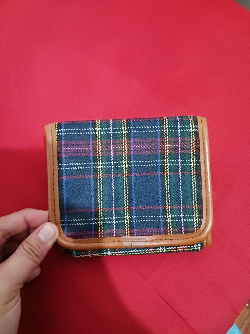 Sans Souci plaid tartan pattern wallet purse (Category: Wallets & Card holders) located in Quezon City. Submitted by rdonelle (Listing ID 1470096931, Image 2). Description: - Design: Multicolor plaid tartan pattern (blue, green, red, white) with brown faux leather trim - Closure: Secure snap button closure - Interior Features: Zippered coin compartment, multiple card slots, and clean fabric lining - Size: Compact design that fits easily into most