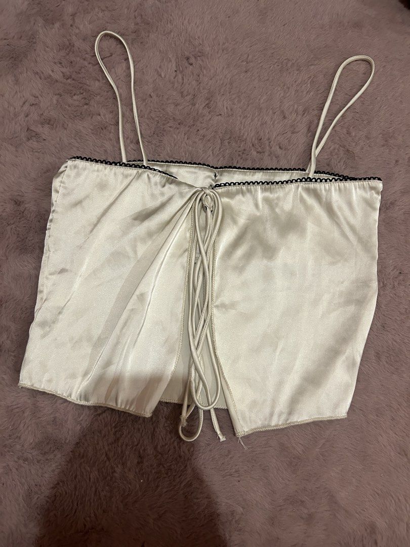 satin backless self tie tank top (Category: Sleeveless) located in Manila. Submitted by lostandfoundbyk (Listing ID 1469980874, Image 2). Description: 💌 originally bought for 300 via orange app ! 🧺 only used once – just needs a bit of love (steaming / ironing) 🪡 no defects! 🧷 xs - semi-med ✨ cream satin, black and bow lace detailing, backless, self tie tank top 📬 mop: gcash 📦 mod: lalamove / gogoxpress (buyer shoulders shipping fee) seller 