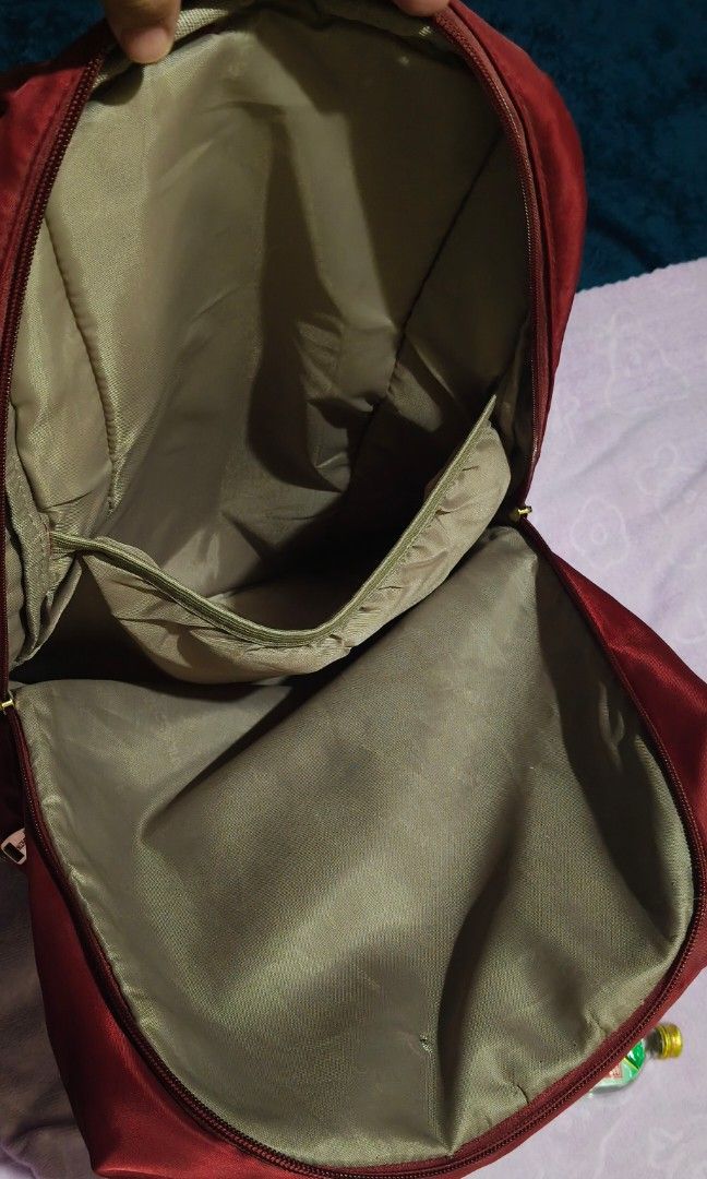 Secosana Nylon Laptop Bag (Category: Backpacks) located in Villasis. Submitted by bunnybabe08 (Listing ID 1470132763, Image 3). Description: • Brand: Secosana • Material: Durable Lightweight Nylon / Canvas • Color / Hardware: Maroon (Dark Red) | Gold-toned zippers and hardware • Condition: Pre-loved multi-compartment daily backpack featuring a lightweight and spacious silhouette. Highly organized exterior layout with three zippered front pockets,