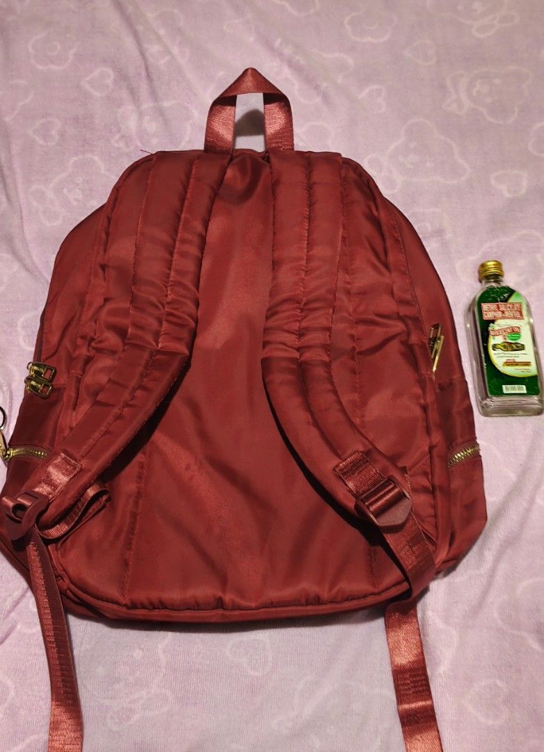 Secosana Nylon Laptop Bag (Category: Backpacks) located in Villasis. Submitted by bunnybabe08 (Listing ID 1470132763, Image 2). Description: • Brand: Secosana • Material: Durable Lightweight Nylon / Canvas • Color / Hardware: Maroon (Dark Red) | Gold-toned zippers and hardware • Condition: Pre-loved multi-compartment daily backpack featuring a lightweight and spacious silhouette. Highly organized exterior layout with three zippered front pockets,