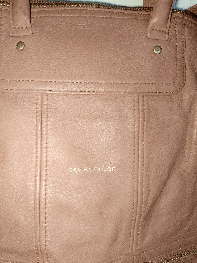 See by Chloe Pink Leather Tote Bag (Category: Luxury Bags & Wallets) located in Manila. Submitted by mjthrifted_second (Listing ID 1469984937, Image 3). Description: - Authentic See by Chloe pink leather tote bag - Elegant gold-tone hardware and gold embossed logo - Dual top handles plus a convenient shoulder strap - Two front zippered pockets with signature round pull tabs - Secure zip top closure with soft slouchy structure and base studs - Pat