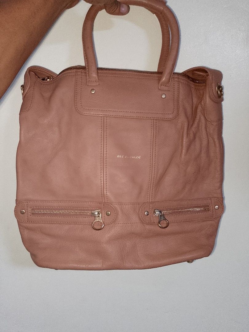 See by Chloe Pink Leather Tote Bag (Category: Luxury Bags & Wallets) located in Manila. Submitted by mjthrifted_second (Listing ID 1469984937, Image 1). Description: - Authentic See by Chloe pink leather tote bag - Elegant gold-tone hardware and gold embossed logo - Dual top handles plus a convenient shoulder strap - Two front zippered pockets with signature round pull tabs - Secure zip top closure with soft slouchy structure and base studs - Pat