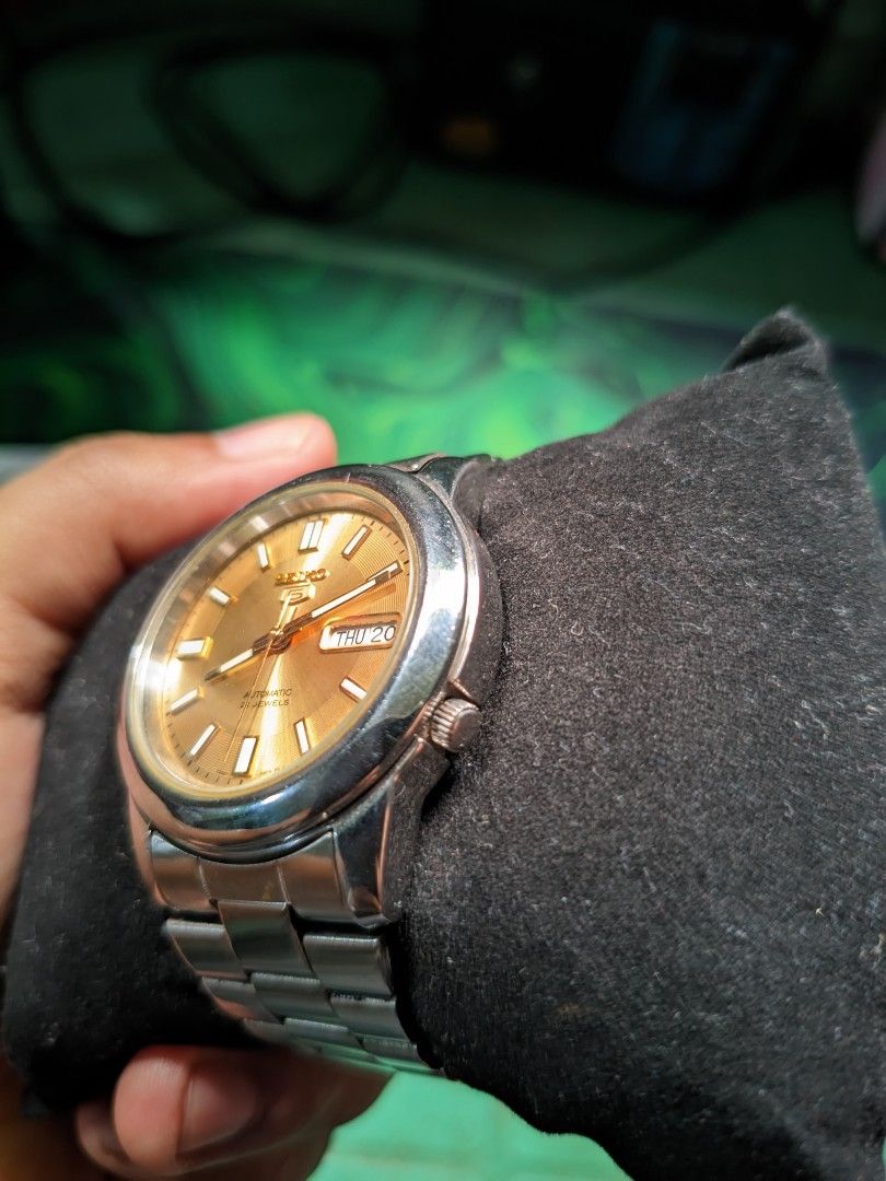 Seiko 5 automatic (Category: Luxury Watches) located in Makati City. Submitted by ointtt (Listing ID 1469966865, Image 3). Description: timeless classic featuring a stunning champagne/gold sunburst dial, sharp lumed hands, and the signature day-date window at 3 o'clock. Brand: Seiko 5 Movement: Automatic (21 Jewels) Dial: Champagne Sunburst with Applied Gold Baton Markers Functions: Complication Case/Bracelet: Stainless Steel.