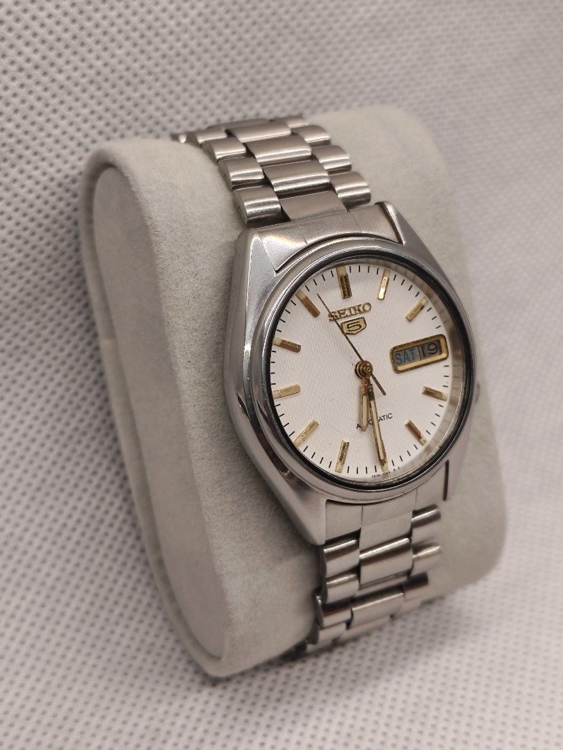 Seiko 5 Automatic reference 7009-876A (Category: Men's Watches) located in Pasig City. Submitted by timepiece-and-co (Listing ID 1469947650, Image 3). Description: Movement: Caliber 7009 automatic (17 jewels). Dial Features: White/silver sunburst dial, applied indices, and an inner bezel ring featuring a 13–24 military hour track. Complication: Day and date window located at the 3 o'clock position.