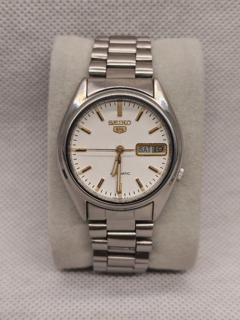Seiko 5 Automatic reference 7009-876A (Category: Men's Watches) located in Pasig City. Submitted by timepiece-and-co (Listing ID 1469947650, Image 1). Description: Movement: Caliber 7009 automatic (17 jewels). Dial Features: White/silver sunburst dial, applied indices, and an inner bezel ring featuring a 13–24 military hour track. Complication: Day and date window located at the 3 o'clock position.