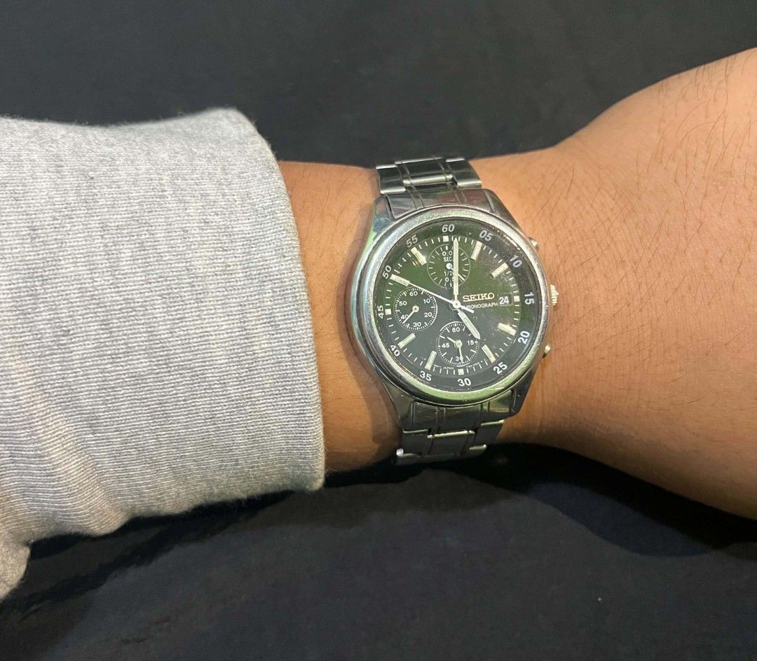 Seiko Chronograph Quartz Steel Watch (Category: Men's Watches) located in Cebu City. Submitted by jbok_watches. (Listing ID 1470101641, Image 2). Description: - Brand: Seiko - Type: Chronograph watch - Dial: Black with multiple sub-dials and date window at 3 o'clock - Material: Silver stainless steel bracelet with engraved logo clasp - Movement: Battery-powered quartz (keeps accurate time) - Condition: Shows visible wear marks on the bracelet and