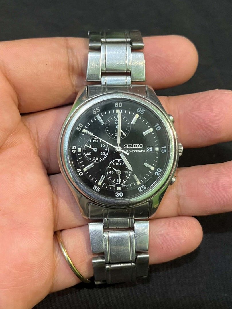 Seiko Chronograph Quartz Steel Watch (Category: Men's Watches) located in Cebu City. Submitted by jbok_watches. (Listing ID 1470101641, Image 3). Description: - Brand: Seiko - Type: Chronograph watch - Dial: Black with multiple sub-dials and date window at 3 o'clock - Material: Silver stainless steel bracelet with engraved logo clasp - Movement: Battery-powered quartz (keeps accurate time) - Condition: Shows visible wear marks on the bracelet and