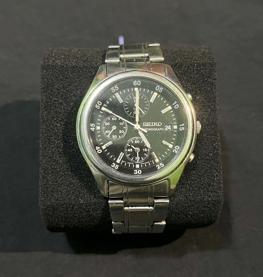Seiko Chronograph Quartz Steel Watch (Category: Men's Watches) located in Cebu City. Submitted by jbok_watches. (Listing ID 1470101641, Image 1). Description: - Brand: Seiko - Type: Chronograph watch - Dial: Black with multiple sub-dials and date window at 3 o'clock - Material: Silver stainless steel bracelet with engraved logo clasp - Movement: Battery-powered quartz (keeps accurate time) - Condition: Shows visible wear marks on the bracelet and