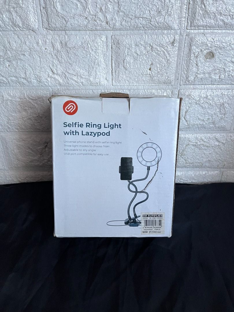 Selfie Ring Light w/ Lazypod (Category: Lighting & Studio Equipment) located in Quezon City. Submitted by shime_diel (Listing ID 1470118194, Image 3). Description: Comes with 3 light intensities: 1. Pure white 2. Middle tone 3. Warm tone The box's contents are: - 1 Ringlight - 1 Phone Holder - Wire with USB Type A I have used this mainly for recording in a small space.