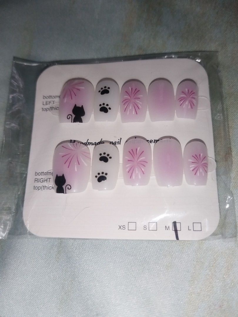 Handmade press-on nail sets - assorted cute designs (Category: Hands & Nails) located in Caloocan City. Submitted by ltriciamae (Listing ID 1469960452, Image 3). Description: 5 DESIGNS SET — ₱100 ONLY TAKE ALL!! - Handcrafted press-on nail enhancements - Short square shape across all 5 styles - Fun designs: red hearts, black cats, green bamboo leaves, and apple dogs - Each set comes sealed on a display card with size indicators - Available per se