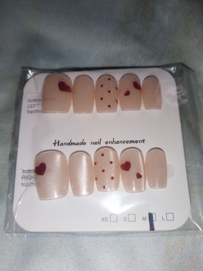 Handmade press-on nail sets - assorted cute designs (Category: Hands & Nails) located in Caloocan City. Submitted by ltriciamae (Listing ID 1469960452, Image 2). Description: 5 DESIGNS SET — ₱100 ONLY TAKE ALL!! - Handcrafted press-on nail enhancements - Short square shape across all 5 styles - Fun designs: red hearts, black cats, green bamboo leaves, and apple dogs - Each set comes sealed on a display card with size indicators - Available per se