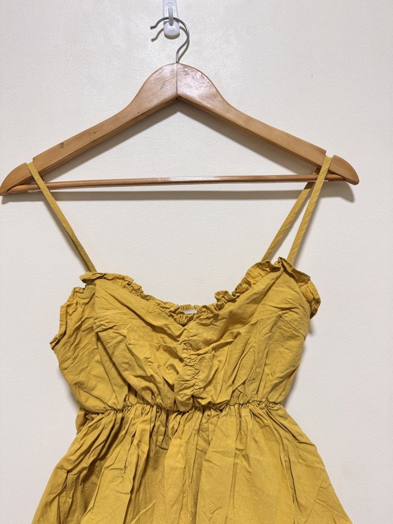 Sexy Top (Category: Sleeveless) located in Manila. Submitted by seayouncey (Listing ID 1470059272, Image 3). Description: - Color: Mustard yellow - Neckline: Sweetheart with delicate ruffle trim - Straps: Adjustable spaghetti straps - Fit: Stretchy smocked bodice and back - Style: Flared flowy peplum waist - Fabric: Lightweight and breathable for warm weather - Versatility: Perfect to pair with denim shorts or a casual skirt.