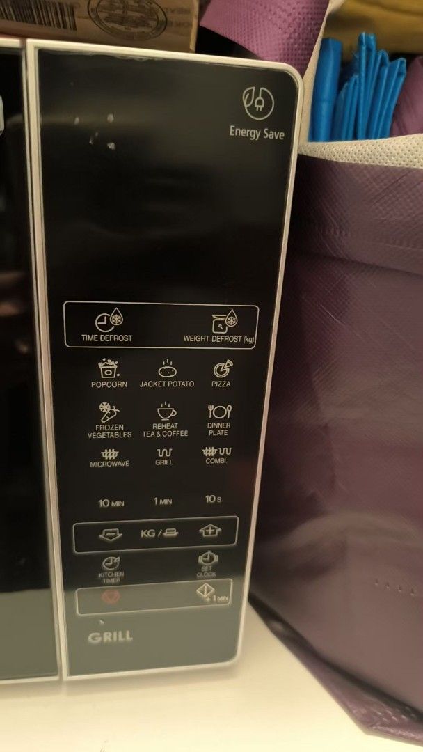 Sharp Microwave with Grill Function (Category: Ovens & Toasters) located in Singapore. Submitted by bellapalace (Listing ID 1470041240, Image 2). Description: - Brand: Sharp Microwave Oven - Key Feature: Built-in grill mode for versatile cooking - Design: Sleek black front panel with chrome pull handle - Controls: Right-side touch control pad with digital display - Pre-sets: Popcorn, jacket potato, pizza, frozen vegetables, and reheat - Efficienc