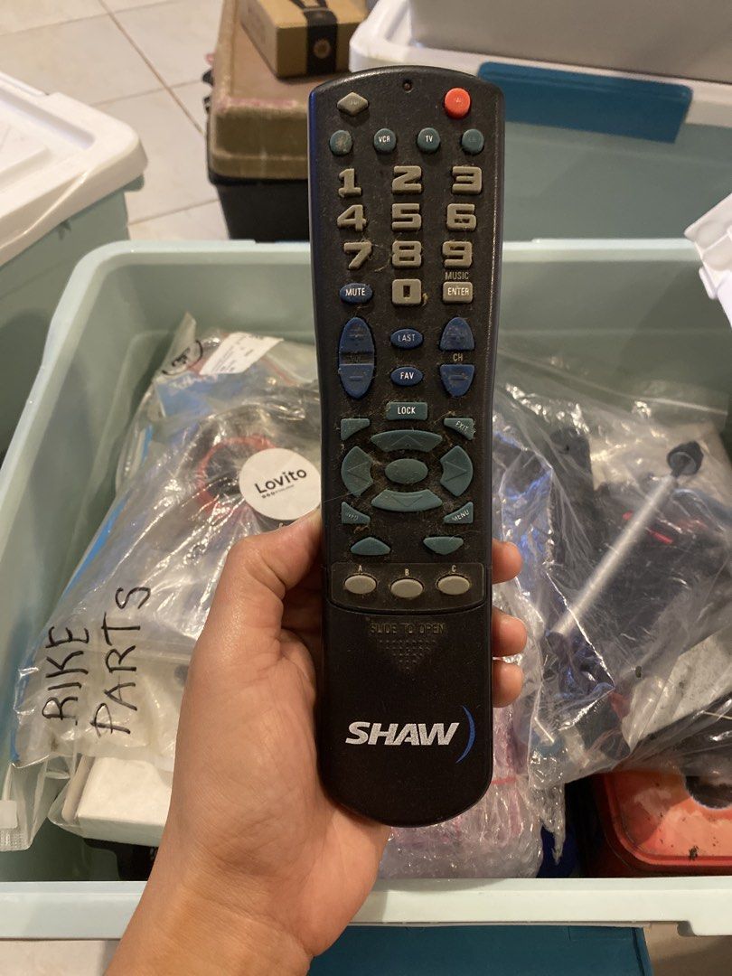 Shaw Cable Remote Control Black (Category: TV Parts & Accessories) located in Muntinlupa City. Submitted by ahermosa (Listing ID 1470093299, Image 1). Description: - 100% Original black remote control featuring Shaw branding - Standard numeric keypad, volume/channel buttons, and navigation pads - Includes original battery cover on the back - Stored well with only light dust and minimal signs of handling.