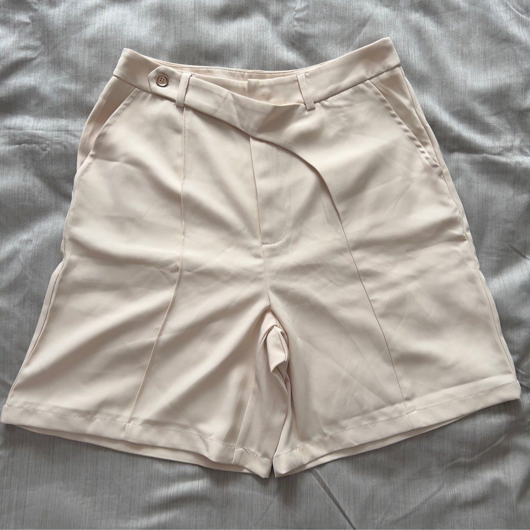 Shein Beige Tailored Shorts With Diagonal Front Strap (Category: Shorts) located in Pasig City. Submitted by jenscloset86 (Listing ID 1469965030, Image 1). Description: Size: MEDIUM • No flaws, no damages • Brand new but washed once. Measurement: Length: 18” Waist: 28”.