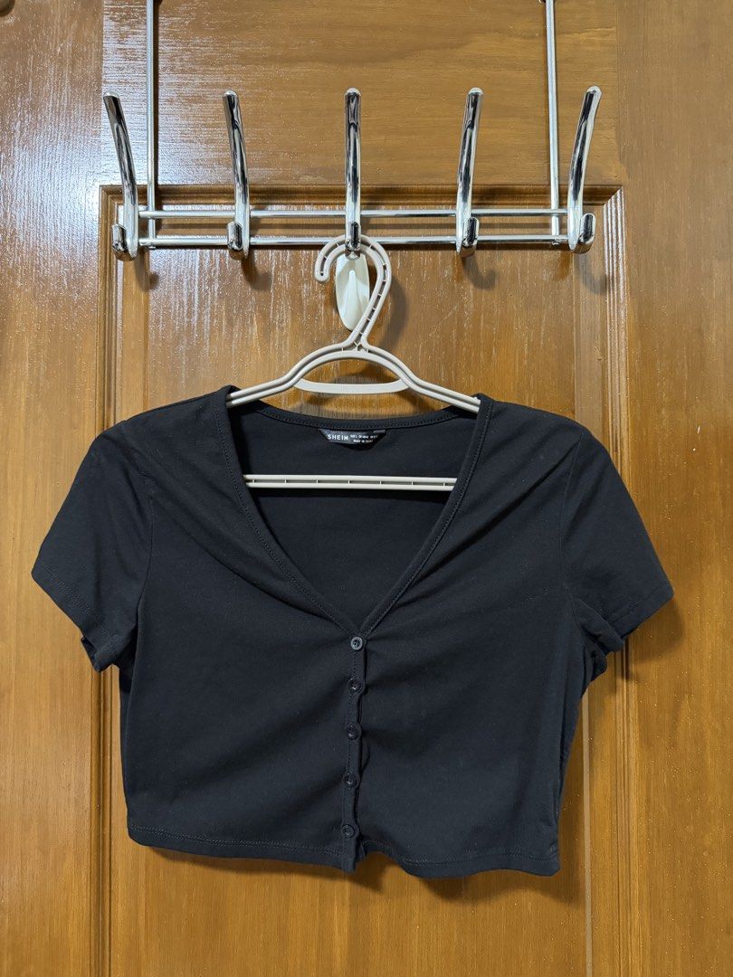 SHEIN Black Button-Up Crop Top Size L (Category: Shirts) located in Bulacan. Submitted by lilthingsco (Listing ID 1470116171, Image 1). Description: - Brand: SHEIN - Style: Casual basic black cropped top with V-neckline, short sleeves, and front button closure - Size: L (Tag size) - Material: Soft and stretchy fabric - Fit: Perfect to pair with high-waisted jeans or skirts - Condition: Worn a few times, freshly washed, and ready to ship.