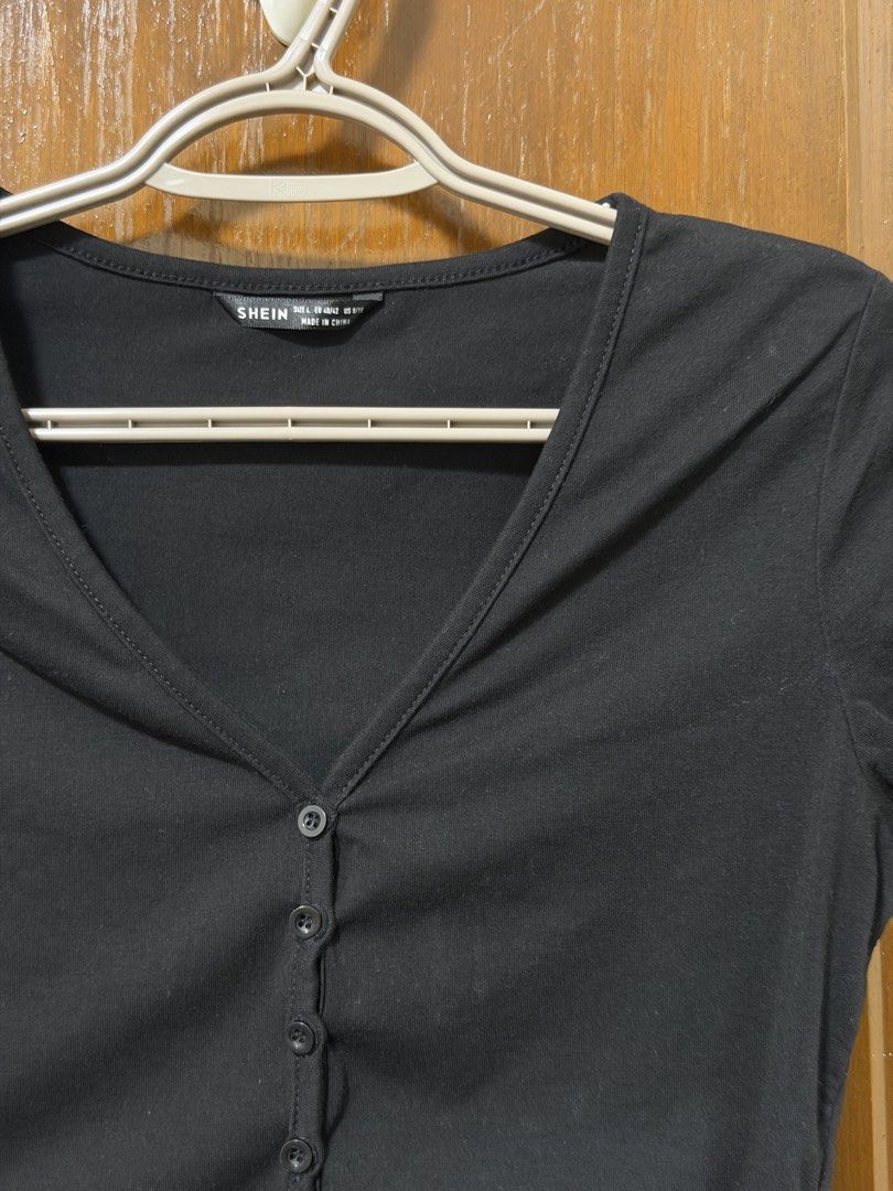 SHEIN Black Button-Up Crop Top Size L (Category: Shirts) located in Bulacan. Submitted by lilthingsco (Listing ID 1470116171, Image 2). Description: - Brand: SHEIN - Style: Casual basic black cropped top with V-neckline, short sleeves, and front button closure - Size: L (Tag size) - Material: Soft and stretchy fabric - Fit: Perfect to pair with high-waisted jeans or skirts - Condition: Worn a few times, freshly washed, and ready to ship.