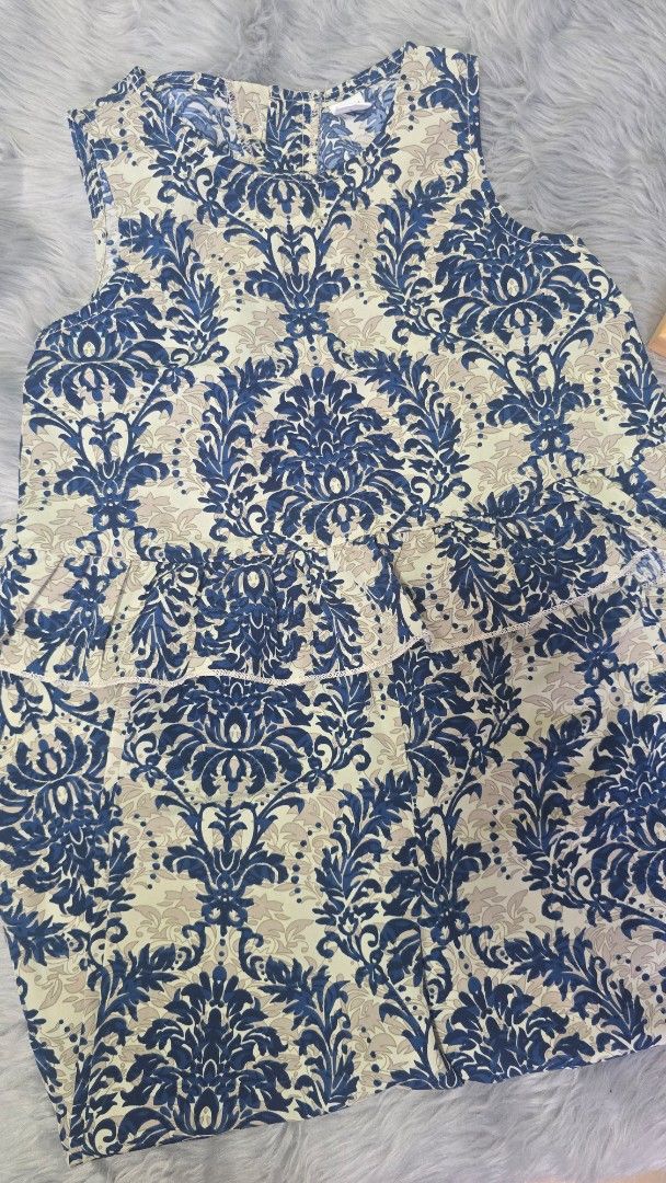 Shein Blue Damask Print Ruffle Top Size 6Y (Category: Sleeveless) located in Cabanatuan. Submitted by belle_1013 (Listing ID 1470022286, Image 1). Description: - Brand: Shein - Size: 6Y - Design: Blue and cream damask print with a layered ruffle front - Back: Small keyhole opening with a button closure - Condition: Excellent, well-maintained - Perfect for: Casual outings, family gatherings, or weekend wear.
