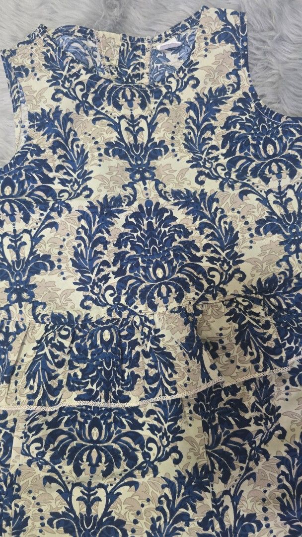 Shein Blue Damask Print Ruffle Top Size 6Y (Category: Sleeveless) located in Cabanatuan. Submitted by belle_1013 (Listing ID 1470022286, Image 3). Description: - Brand: Shein - Size: 6Y - Design: Blue and cream damask print with a layered ruffle front - Back: Small keyhole opening with a button closure - Condition: Excellent, well-maintained - Perfect for: Casual outings, family gatherings, or weekend wear.