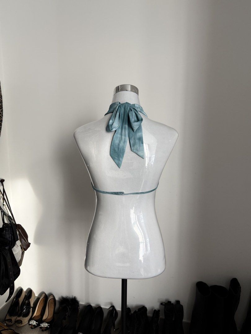 SHEIN Blue Halter Crop Top Size XS (Category: Sleeveless) located in Manila. Submitted by janalulu (Listing ID 1469970085, Image 2). Description: - Brand: Shein - Color: Light Blue - Size: Extra Small (XS) - Design: Halter style with a front round metallic buckle, open back, and ribbon tie - Fit: Cropped length - Material: Very lightweight, ideal for warm weather and parties.