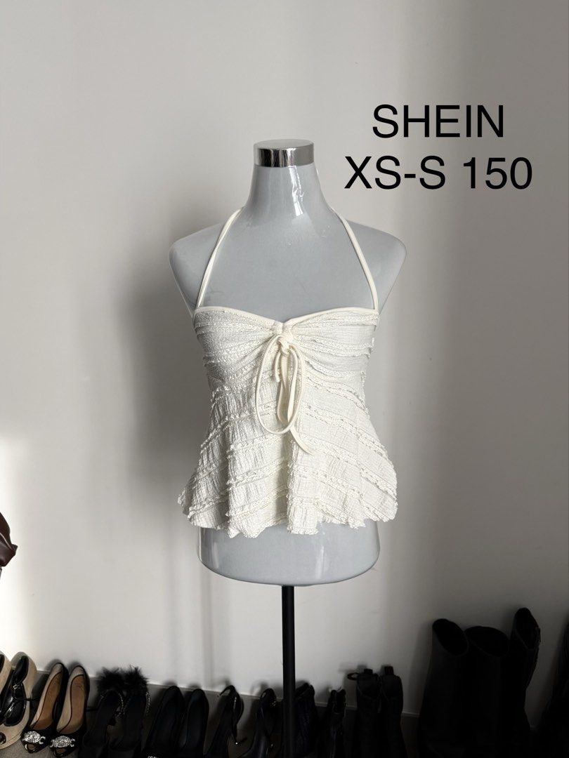 SHEIN Halter Ruched Top White XS-S (Category: Sleeveless) located in Manila. Submitted by janalulu (Listing ID 1469970254, Image 1). Description: - Brand: SHEIN - Size: Fits XS to S - Color: White - Style: Halter top with adjustable straps and flared hem - Details: All-over ruched texture with a cute front tie - Condition: Great, easy to pair with jeans or skirts for warm weather.