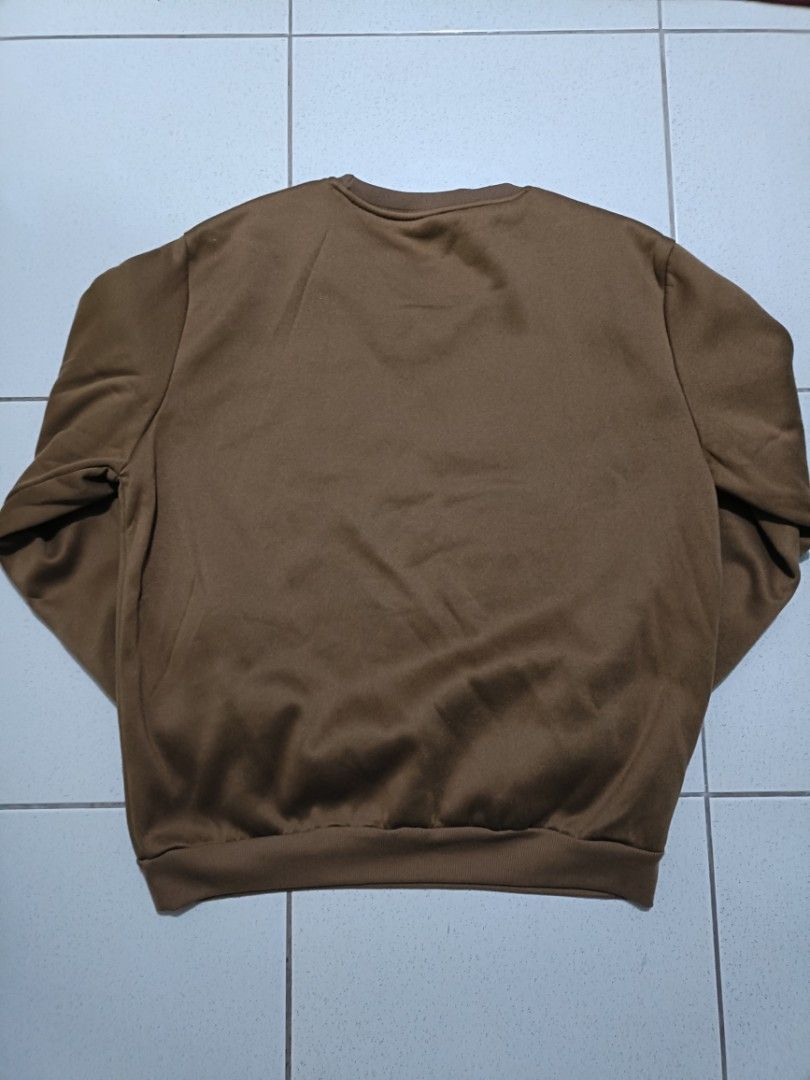 SHEIN Keep Smile Brown Sweatshirt Size (Category: Coats, Jackets and Outerwear) located in Manila. Submitted by quartz.rewind (Listing ID 1470111486, Image 2). Description: "🔥 10% OFF if you buy any 2 items! / 15% OFF for 3+ items. Shipping can be combined to save you money. Valid this week only!" Description: Up for grabs is a cozy coffee-brown crewneck sweatshirt from SHEIN. Features a unique white gothic text detail knitted along the collar r