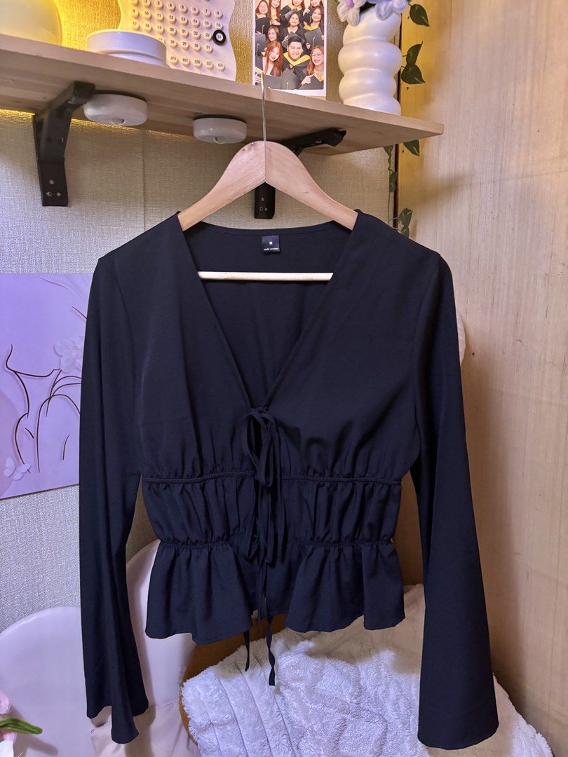 Shein Mod Black Peplum Blouse Size M (Category: Blouses) located in Manila. Submitted by joe_fashion1234 (Listing ID 1470136750, Image 2). Description: - Brand: Shein Mod - Size: Medium (tag attached) - Color: Black - Design: V-neck with double tie-front strings and long flared sleeves - Fit: Smocked elastic waist with a flowy peplum hem - Condition: Brand new, clean, and no flaws noticed.
