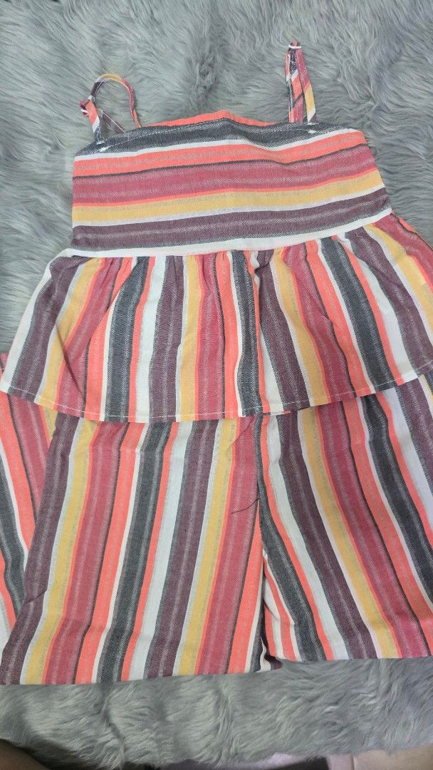 Shein Multi-color Striped Romper Size 7Y (Category: Rompers) located in Cabanatuan. Submitted by belle_1013 (Listing ID 1470023102, Image 1). Description: - Brand: Shein - Item: Multicolored striped romper - Size: 7Y - Features: Bright stripes (orange, yellow, grey, maroon, white), spaghetti straps, layered ruffle design - Origin: Made in China - Condition/Style: Fun and colorful, perfect for casual wear.