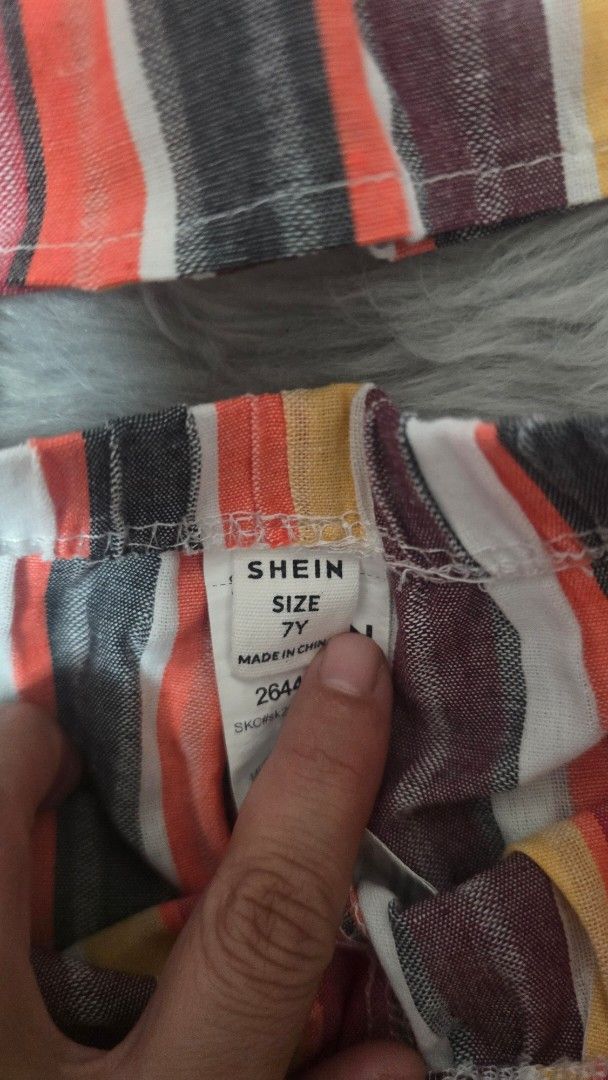 Shein Multi-color Striped Romper Size 7Y (Category: Rompers) located in Cabanatuan. Submitted by belle_1013 (Listing ID 1470023102, Image 2). Description: - Brand: Shein - Item: Multicolored striped romper - Size: 7Y - Features: Bright stripes (orange, yellow, grey, maroon, white), spaghetti straps, layered ruffle design - Origin: Made in China - Condition/Style: Fun and colorful, perfect for casual wear.