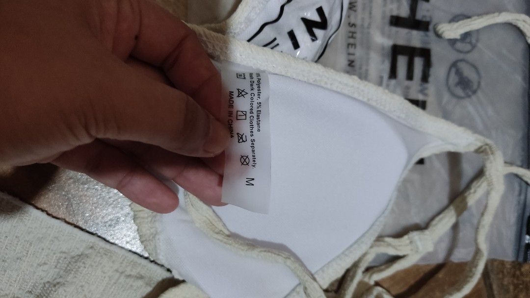 SHEIN Textured Bikini Set with Sarong Size M (Category: Bikinis & Swimsuits) located in Mangatarem. Submitted by itsumo_kokoro (Listing ID 1469987938, Image 3). Description: - Brand: SHEIN - Item: 3-Piece Bikini Set with Matching Sarong Wrap - Color: Cream (Textured Fabric) - Size: M - Material: 95% Polyester, 5% Elastane - Inclusions: Triangle top with ties, matching bottom, sheer wrap skirt, and original ziplock packaging - Condition: Brand new