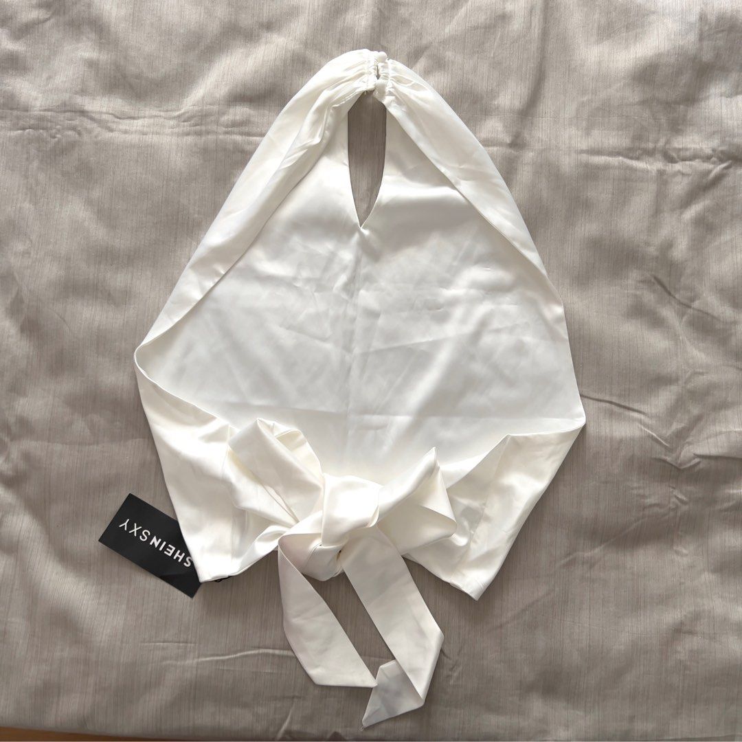 SHEINSXY White Halter Tie-Back Satin Top (Category: Sleeveless) located in Pasig City. Submitted by jenscloset86 (Listing ID 1470028553, Image 2). Description: Brand: SHEIN Size: Medium (best fit Small-Medium) BRAND NEW • BRAND NEW • Never used, never worn. • No flaws, no damages. Measurement: Length: 27” Bust: 30-34” when stretched Waist: 26-28”.