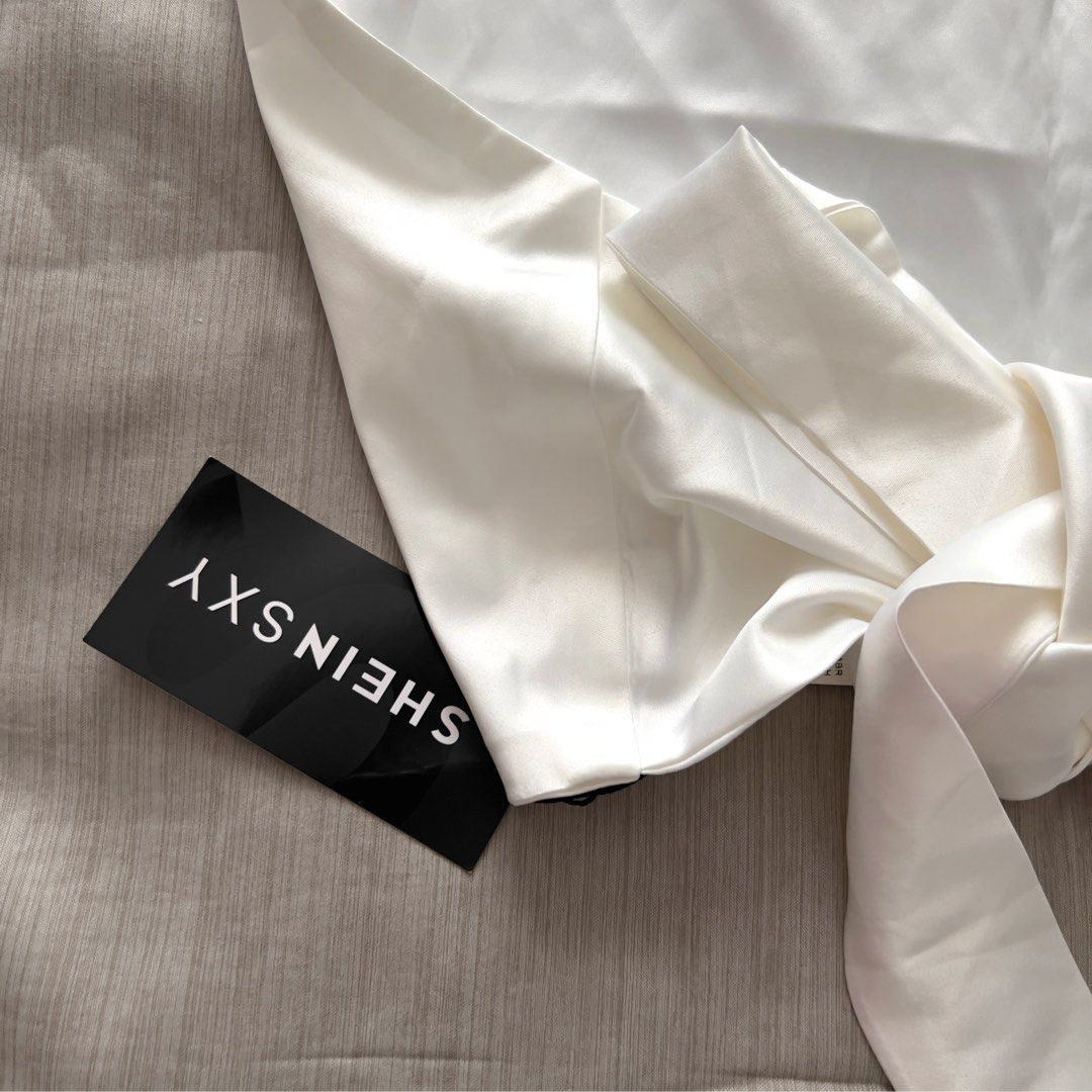 SHEINSXY White Halter Tie-Back Satin Top (Category: Sleeveless) located in Pasig City. Submitted by jenscloset86 (Listing ID 1470028553, Image 3). Description: Brand: SHEIN Size: Medium (best fit Small-Medium) BRAND NEW • BRAND NEW • Never used, never worn. • No flaws, no damages. Measurement: Length: 27” Bust: 30-34” when stretched Waist: 26-28”.