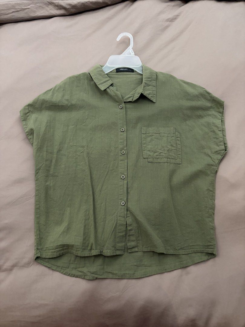 Short Sleeve Button up (Category: Shirts) located in Pasig City. Submitted by gdeclutterwithme (Listing ID 1470114477, Image 1). Description: - Color: Neutral olive green - Size: L - Fit: Relaxed fit with a curved hemline - Details: Classic collar, front chest pocket, button-down closure - Fabric: Very Lightweight and breathable for warm weather dm for more deets! 💕.