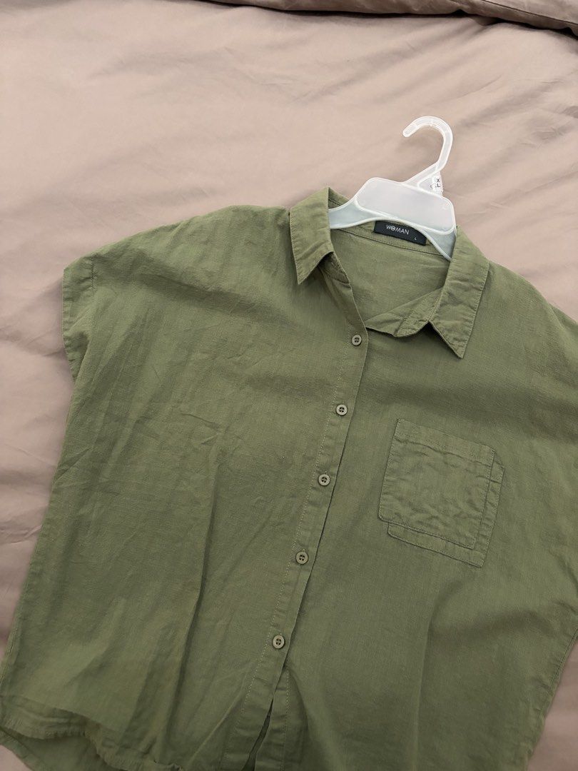 Short Sleeve Button up (Category: Shirts) located in Pasig City. Submitted by gdeclutterwithme (Listing ID 1470114477, Image 2). Description: - Color: Neutral olive green - Size: L - Fit: Relaxed fit with a curved hemline - Details: Classic collar, front chest pocket, button-down closure - Fabric: Very Lightweight and breathable for warm weather dm for more deets! 💕.