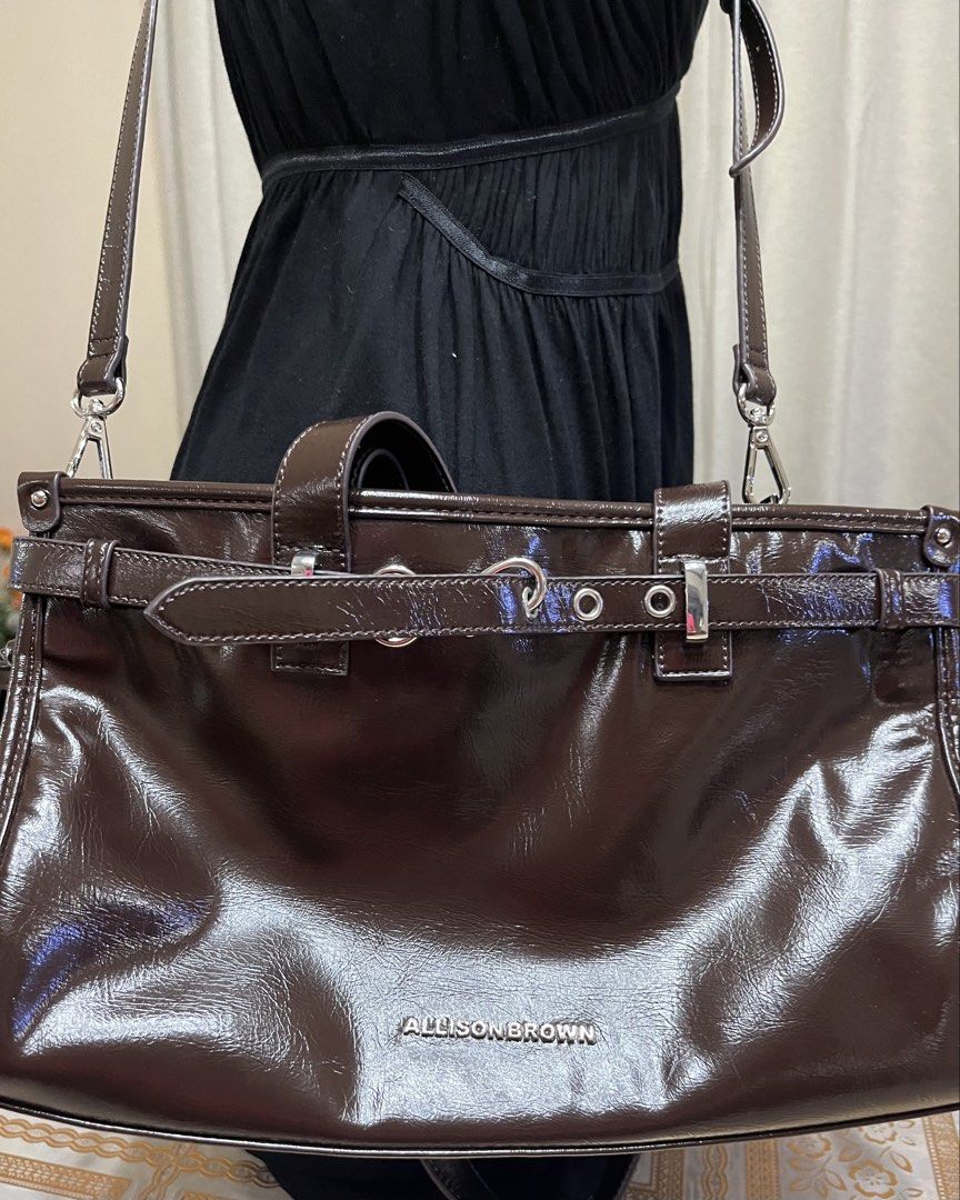 Shoulder bag (Category: Shoulder Bags) located in Bacoor. Submitted by ayit. (Listing ID 1470067719, Image 2). Description: Bnew japan gling orig - Brand: Allison Brown - Color: Glossy dark brown - Style: Shoulder bag / Crossbody bag - Features dual top handles and a detachable, adjustable long strap - Spacious main compartment with interior zipper and slip pockets - Chic belt and metal ring accent on the front - Condition: Well-maintained and re