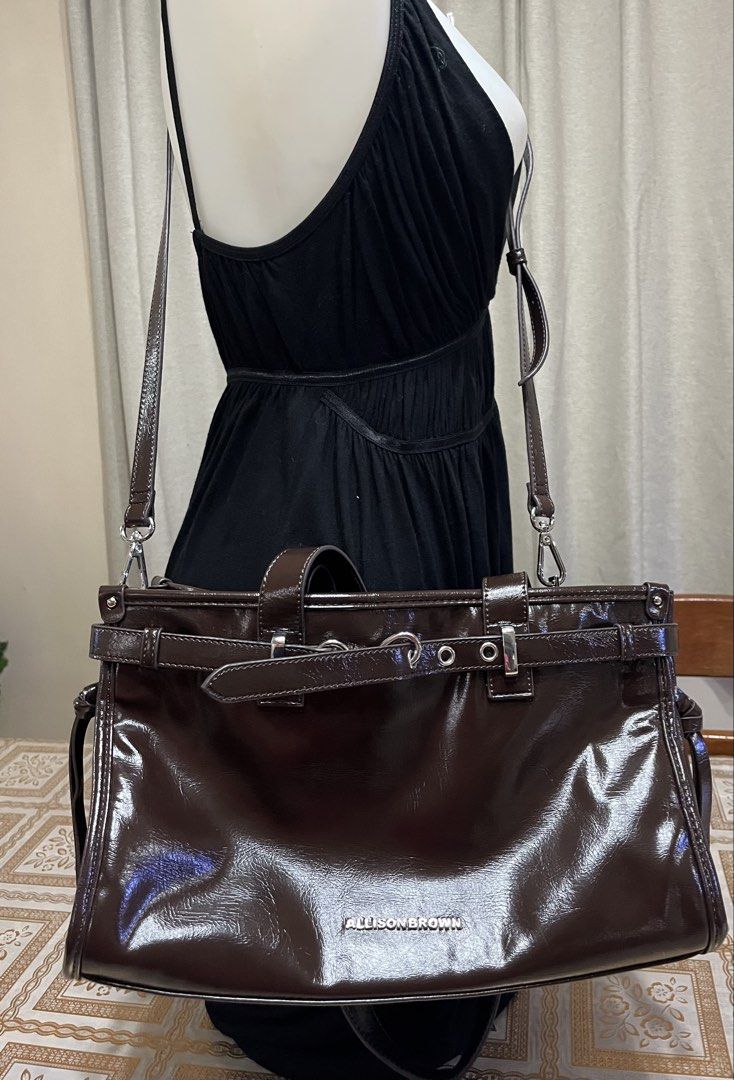 Shoulder bag (Category: Shoulder Bags) located in Bacoor. Submitted by ayit. (Listing ID 1470067719, Image 3). Description: Bnew japan gling orig - Brand: Allison Brown - Color: Glossy dark brown - Style: Shoulder bag / Crossbody bag - Features dual top handles and a detachable, adjustable long strap - Spacious main compartment with interior zipper and slip pockets - Chic belt and metal ring accent on the front - Condition: Well-maintained and re